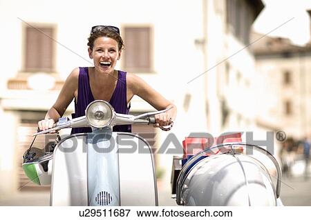 Woman driving a vespa View Large Photo Image Stock Photo - Woman driving a vespa. Fotosearch