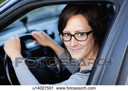 Woman driving car View Large Photo Image Stock Image - Woman driving car. Fotosearch