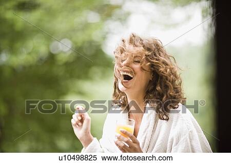 Stock Photography - Woman enjoying the early morning. Fotosearch