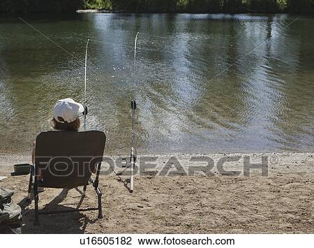Woman fishing on river bank View Large Photo Image Stock Image - Woman fishing on river bank. Fotosearch