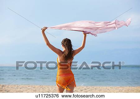 Woman flying cloth at the beach View Large Photo Image Stock Photograph - Woman flying cloth at the beach. Fotosearch