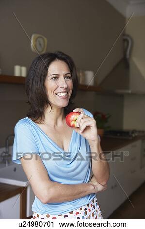 Woman going to eat apple View Large Photo Image Stock Image - Woman going to eat apple. Fotosearch