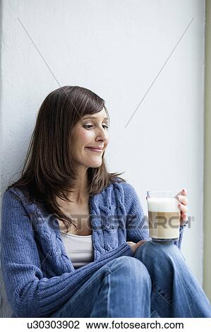 Stock Image - Woman having coffee break. Fotosearch