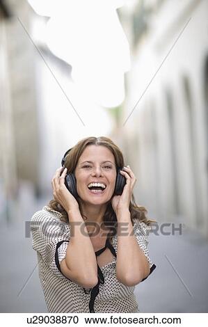 Stock Image - Woman hearing music. Fotosearch