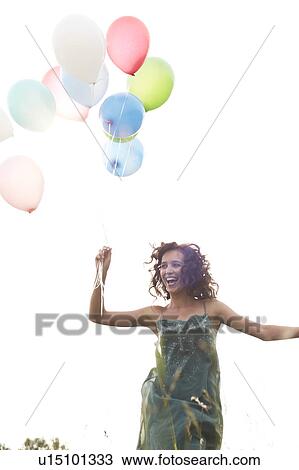 Woman holding air balloons View Large Photo Image Stock Image - Woman holding air balloons. Fotosearch
