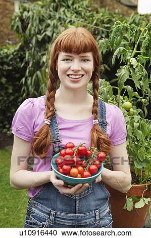 Woman holding bowl with picked tomatoes View Large Photo Image Stock Image - Woman holding bowl with picked tomatoes. Fotosearch