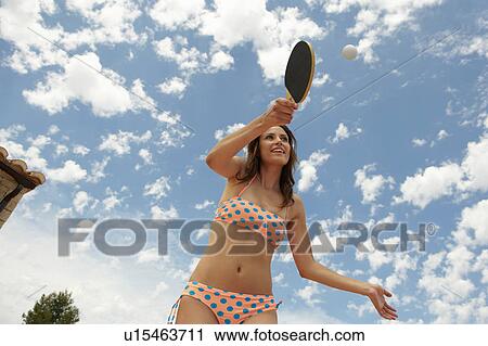 Woman holding racket seen from below View Large Photo Image Stock Image - Woman holding racket seen from below. Fotosearch