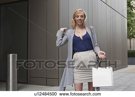 Woman holding shopping bag View Large Photo Image Stock Image - Woman holding shopping bag. Fotosearch