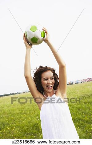 Woman holding soccer ball View Large Photo Image Stock Photograph - Woman holding soccer ball. Fotosearch