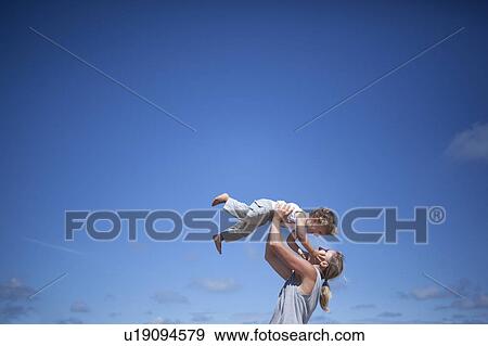 Stock Photo - Woman holding son. Fotosearch