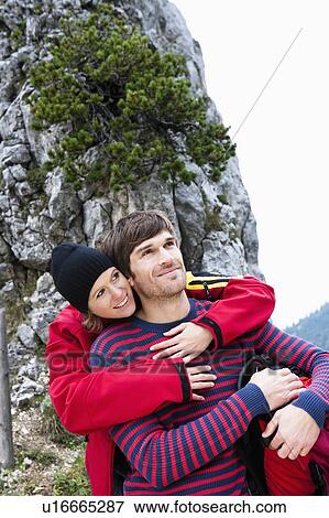 Stock Photo - Woman hugging man from behind. Fotosearch