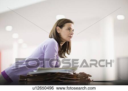 Stock Photograph - Woman in an office. Fotosearch