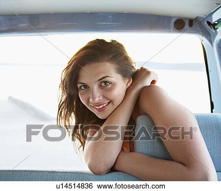 Stock Photograph - Woman in back of car. Fotosearch