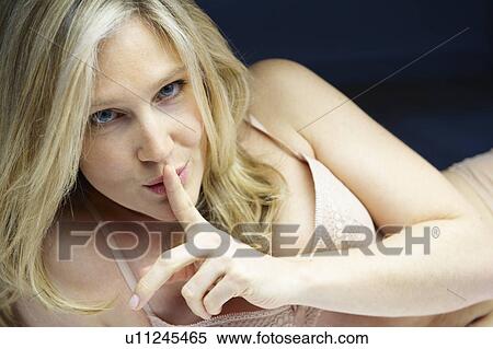 Woman in bed, gesturing shhh View Large Photo Image Stock Photography - Woman in bed, gesturing shhh. Fotosearch