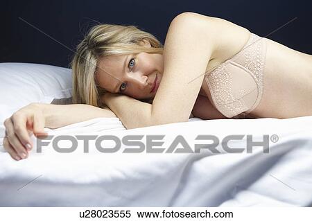 Woman in bed, looking at camera View Large Photo Image Stock Photography - Woman in bed, looking at camera. Fotosearch