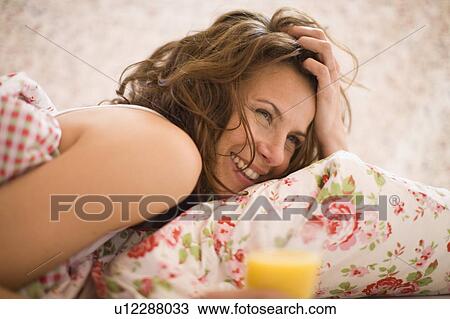 Stock Image - Woman in bed. Fotosearch