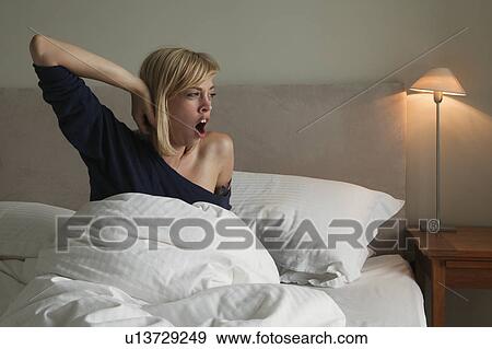 Woman in bed yawning View Large Photo Image Stock Photo - Woman in bed yawning. Fotosearch