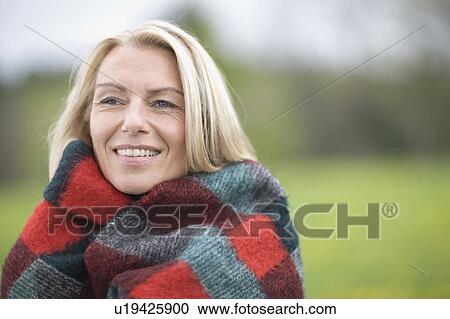 Stock Image - Woman in blanket. Fotosearch