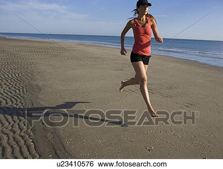 Woman jogging on the beach View Large Photo Image Stock Photograph - Woman jogging on the beach. Fotosearch