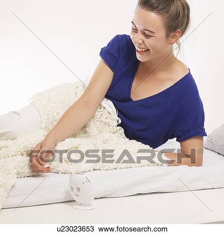 Woman laughing with alarm clock View Large Photo Image Stock Image - Woman laughing with alarm clock. Fotosearch