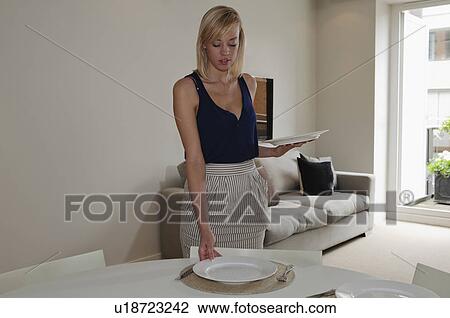 Woman laying the table View Large Photo Image Stock Image - Woman laying the table. Fotosearch