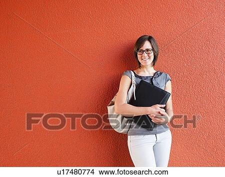 Woman leaning on wall View Large Photo Image Picture - Woman leaning on wall. Fotosearch