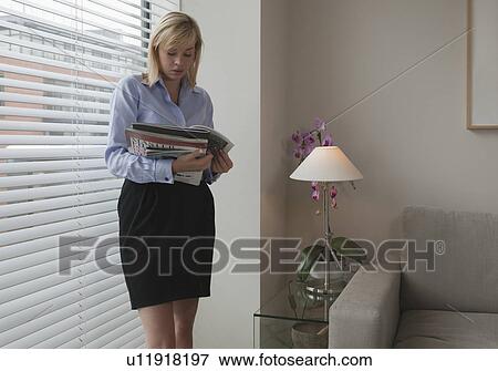 Woman looking at magazines View Large Photo Image Stock Photo - Woman looking at magazines. Fotosearch