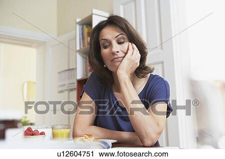 Woman looking bored View Large Photo Image Stock Image - Woman looking bored. Fotosearch