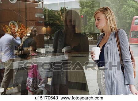 Woman looking in shop window View Large Photo Image Stock Image - Woman looking in shop window. Fotosearch
