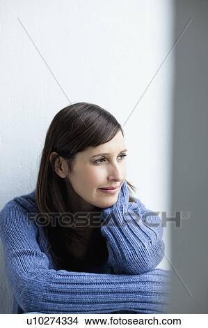 Picture - Woman looking out of window. Fotosearch
