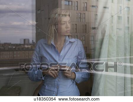 Woman looking out of window View Large Photo Image Picture - Woman looking out of window. Fotosearch
