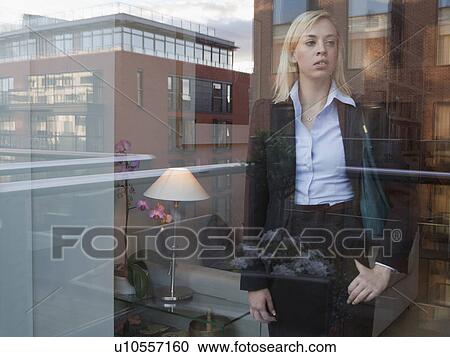 Woman looking out of window View Large Photo Image Stock Image - Woman looking out of window. Fotosearch