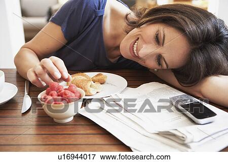 Woman nibbling raspberries View Large Photo Image Stock Photo - Woman nibbling raspberries. Fotosearch