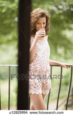 Woman on a balcony View Large Photo Image Picture - Woman on a balcony. Fotosearch