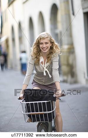 Woman on a bike View Large Photo Image Stock Image - Woman on a bike. Fotosearch