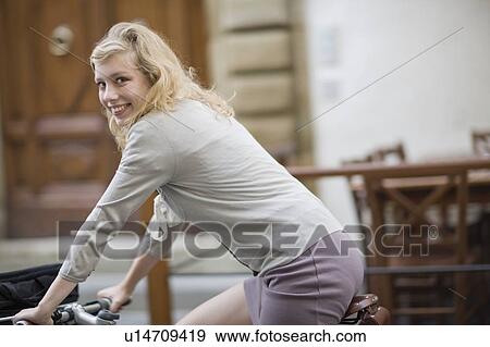 Woman on a bike View Large Photo Image Stock Photo - Woman on a bike. Fotosearch