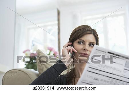 Woman on phone with document View Large Photo Image Picture - Woman on phone with document. Fotosearch