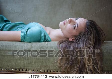 Stock Image - Woman on sofa. Fotosearch