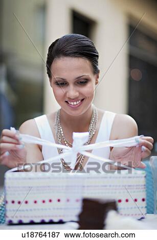 Woman opening present View Large Photo Image Stock Photo - Woman opening present. Fotosearch