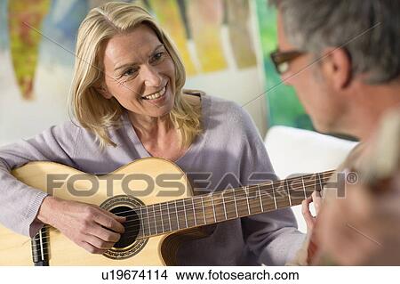 Picture - Woman playing guitar. Fotosearch
