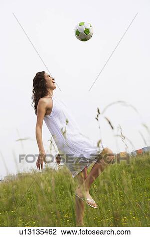 Stock Image - Woman playing soccer. Fotosearch
