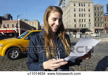 Woman reading a letter in the street View Large Photo Image Picture - Woman reading a letter in the street. Fotosearch