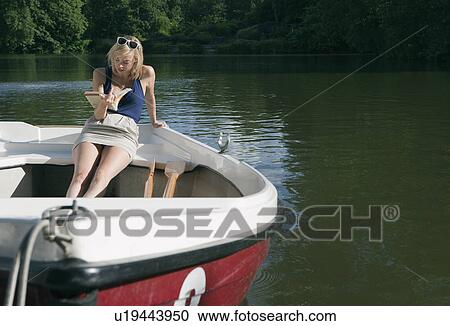 Woman reading book on rowing boat View Large Photo Image Stock Image - Woman reading book on rowing boat. Fotosearch