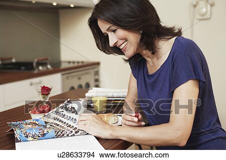 Woman reading magazine View Large Photo Image Picture - Woman reading magazine. Fotosearch