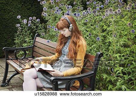 Woman reading, sitting on bench in park View Large Photo Image Stock Photo - Woman reading, sitting on bench in park. Fotosearch