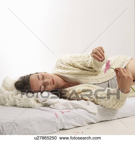 Woman reclined with pink flower View Large Photo Image Stock Image - Woman reclined with pink flower. Fotosearch
