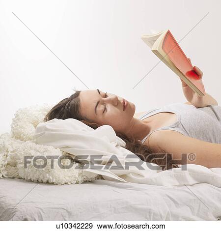 Woman reclined with reading book View Large Photo Image Stock Photo - Woman reclined with reading book. Fotosearch
