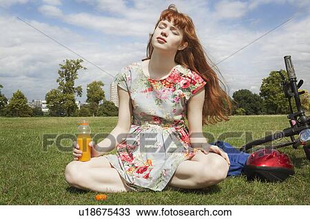 Woman relaxing in park View Large Photo Image Stock Image - Woman relaxing in park. Fotosearch