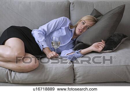 Stock Photo - Woman relaxing on sofa. Fotosearch