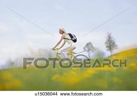 Picture - Woman riding bike. Fotosearch